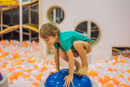 The boy has fun in an indoor playgroundの写真素材