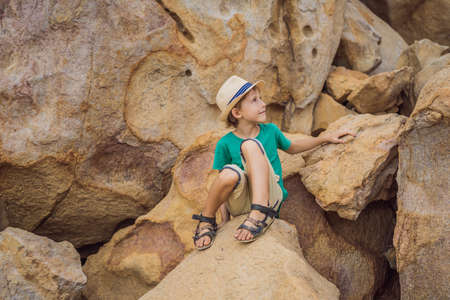 Young boy climbing on a rock, vacation conceptの写真素材