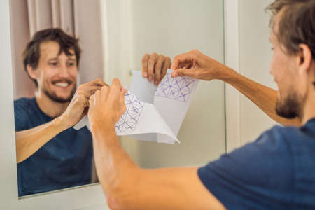 Extremly tired young woman fills in the self-isolation calendar for 14 days, home alone. self-isolation at home, quarantine due to pandemic COVID 19. Mental health problems in self-isolation at homeの写真素材