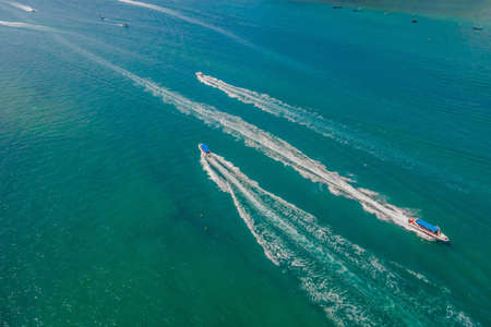 Aerial view of small boat flowing in sea, travel and vacation conceptの写真素材
