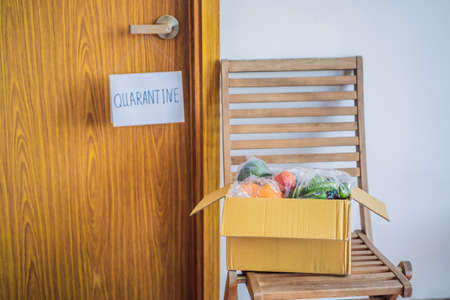 Home delivery food during virus outbreak, coronavirus panic and pandemics. Stay safe Coronavirus covid-19 quarantine sign at Front door, quarantine sign at homeの写真素材