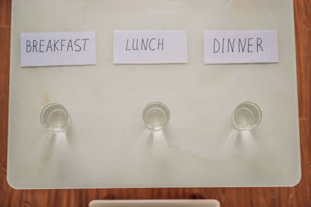 Intermittent fasting. Replacing meals with water. Intermittent fasting concept, top view
