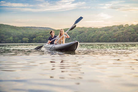 Man and woman swims on kayak in the sea on background of island. Kayaking concept.Kayaking concept...