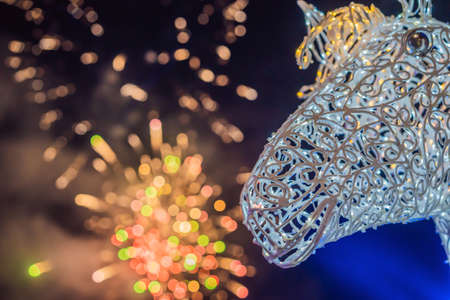 Beautiful colorful holiday fireworks in the evening sky with majestic cloudsの写真素材
