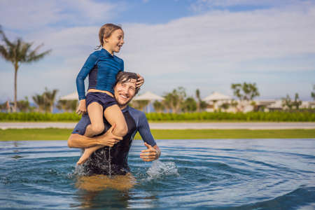 Father and Son having fun in the swimming poolの写真素材