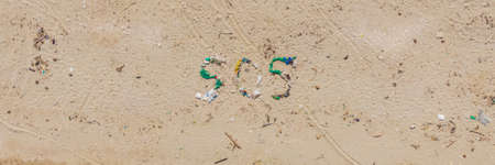 Environmental problem. Ecology concept. Plastic on the beach with sos writing. Spilled garbage on the beach BANNER, LONG FORMATの写真素材