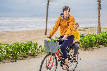 Father with his son having a weekend excursion on bike on a summer day in beautiful landscape