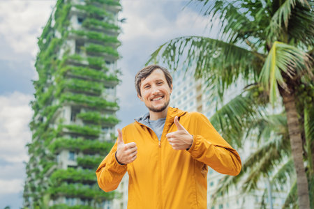 man looks at Eco architecture. Green cafe with hydroponic plants on the facade. Ecology and green...