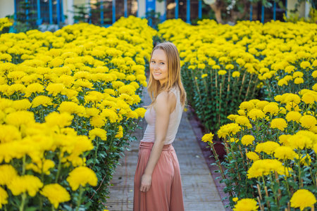 Beautiful Caucasian tourist woman in Tet holidays. Vietnam Chinese Lunar New Year in springtimeの写真素材