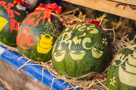 Water melons with festive engraving on Tet Eve. Tet is Lunar New Year and celebrated during four days in Vietnamの写真素材