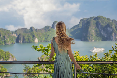 Attractive woman in a dress is traveling in Halong Bay. Vietnam. Travel to Asia, happiness emotion, summer holiday concept. Picturesque sea landscape. Ha Long Bay, Vietnamの写真素材