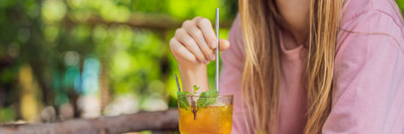 Eco friendly woman using reusable stainless steel straw to drink fruit tea BANNER, LONG FORMATの写真素材