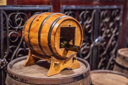 Wine barrels stacked in the old cellar of the winery