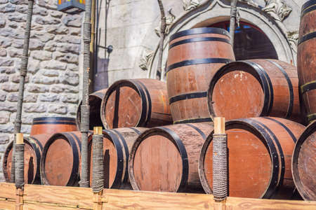 Wine barrels stacked in the old cellar of the winery