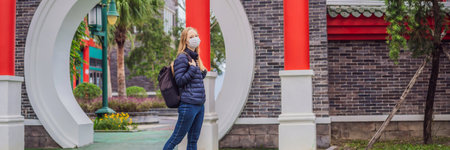 BANNER, LONG FORMAT traveler in medical mask stopped on the street and looking at the Japanese,...