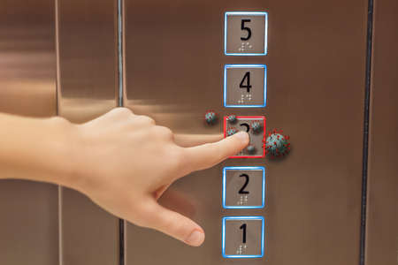 Hand finger press button in elevator with virus.  Button with virus around the elevator or lift....