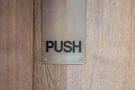 the inscription push on the wooden doorの写真素材