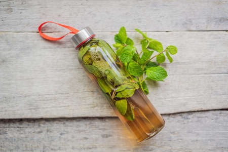 Kombucha tea super food pro biotic beverage in glasses with mint on wooden background - homemade healthy organic fermented probiotic drinkの写真素材