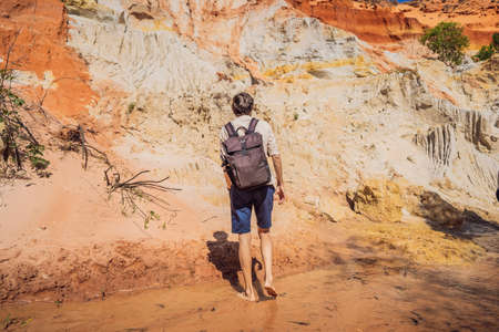 Man tourist on the Fairy stream among the red dunes, Muine, Vietnam.の写真素材