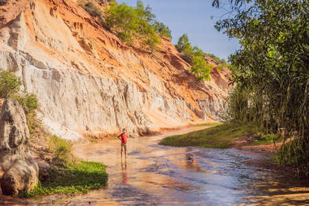Boy tourist on the Fairy stream among the red dunes, Muine, Vietnam. Vietnam opens borders after quarantineの写真素材