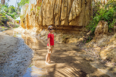 Boy tourist on the Fairy stream among the red dunes, Muine, Vietnam. Vietnam opens borders after quarantineの写真素材