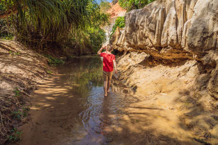Boy tourist on the Fairy stream among the red dunes, Muine, Vietnam. Vietnam opens borders after quarantineの写真素材