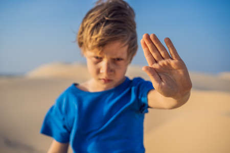 Boy calls for an end to climate change. No trash, no greenhouse gases, reduced carbon dioxide...