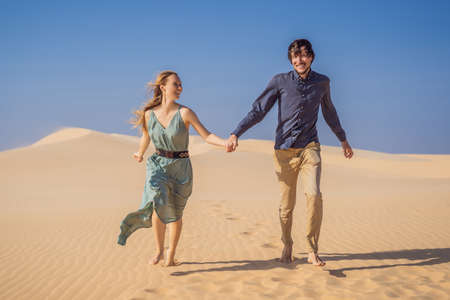 Happy couple healthy lifestyle affectionate outdoors in nature during hiking travel. Man and woman hikers smiling in mountain desert landscape. Tourism opens after quarantineの写真素材