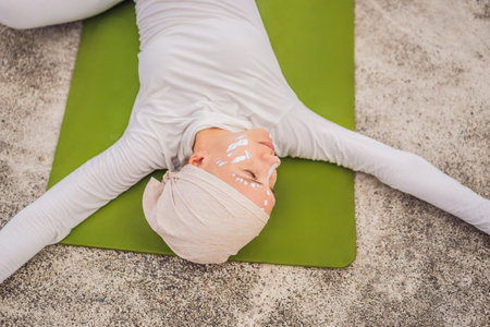 Kundalini yoga woman in white clothes and turban practices yoga kundalini on the background of the...