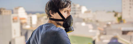 BANNER, LONG FORMAT Close up portrait of young man in respirator mask against the background of the...