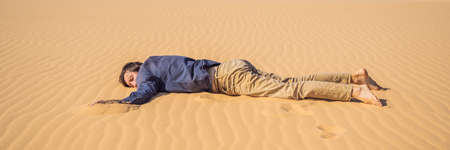 Exhausted man in the desert. Apathy, fatigue, exhaustion, mental disorders concept. Mental health BANNER, LONG FORMATの写真素材
