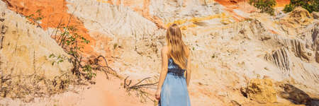 Woman tourist on the Fairy stream among the red dunes, Muine, Vietnam.