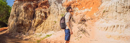 Man tourist on the Fairy stream among the red dunes, Muine, Vietnam.