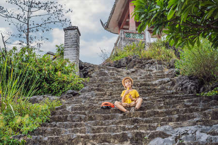Boy tourist on top pagoda of Hang Mua temple, rice fields, Ninh Binh, Vietnam.の写真素材