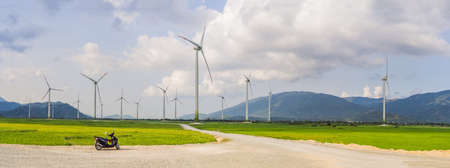 Wind power plant. green meadow with Wind turbines generating electricity