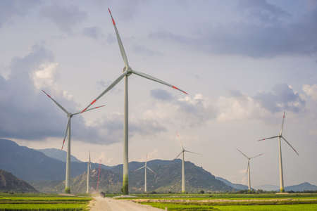 Wind power plant. green meadow with Wind turbines generating electricityの写真素材
