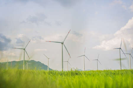 Wind power plant. green meadow with Wind turbines generating electricity