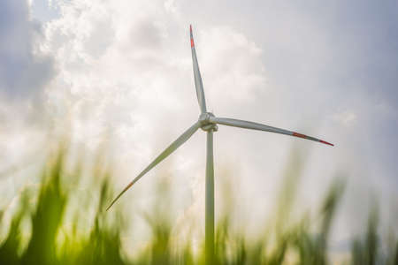 Wind power plant. green meadow with Wind turbines generating electricity
