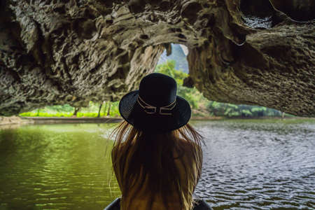 Woman tourist in boat on the lake Tam Coc, Ninh Binh, Viet nam. It's is UNESCO World Heritage Site, renowned for its boat cave tours.の写真素材