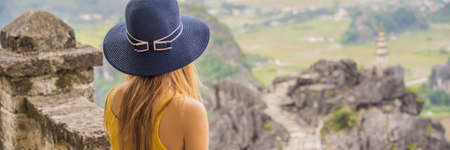 Woman tourist on top pagoda of Hang Mua temple, rice fields, Ninh Binh, Vietnam.の写真素材