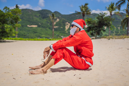 Santa Claus relaxing on sea beach - christmas or happy new year concept. Christmas in the tropics after quarantine was liftedの写真素材
