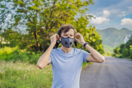 Runner wearing medical mask, pandemic. Sport, Active life in quarantine surgical sterilizing face...