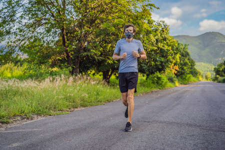 Runner wearing medical mask, pandemic. Sport, Active life in quarantine surgical sterilizing face mask protection.の写真素材