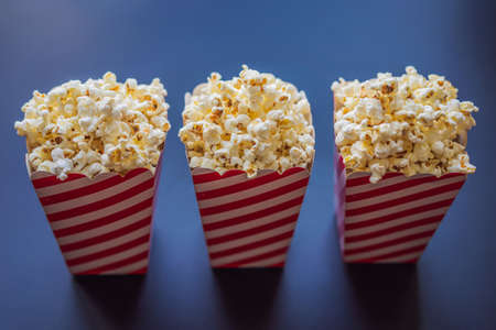 Popcorn in red and white container on a dark backgroundの写真素材
