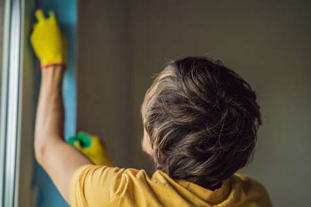 Builder or handyman is engaged in the repair or installation of windowsの写真素材