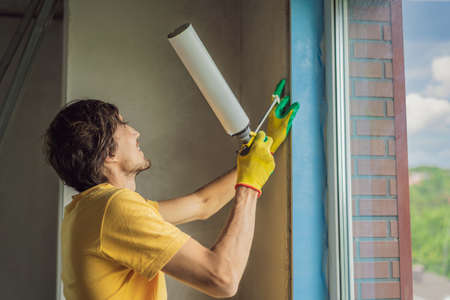 Builder or handyman is engaged in the repair or installation of windowsの写真素材
