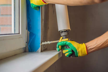 Builder or handyman is engaged in the repair or installation of windowsの写真素材