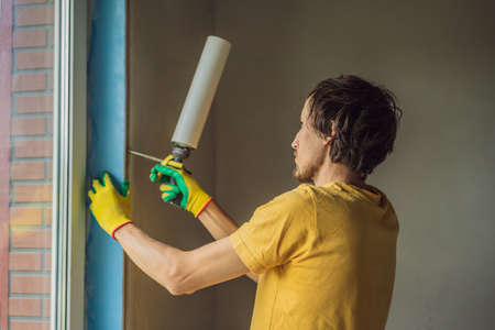 Builder or handyman is engaged in the repair or installation of windowsの写真素材