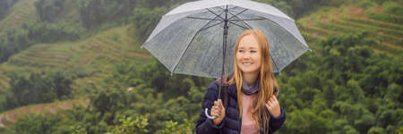 Woman tourist with umbrella in Sapa in the fog, Northwest Vietnam.の写真素材