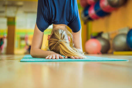 Young beautiful woman practicing aerial yoga in gym. Lifestyleの写真素材